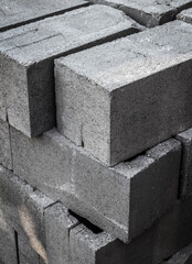 Large stack of gray concrete building blocks.