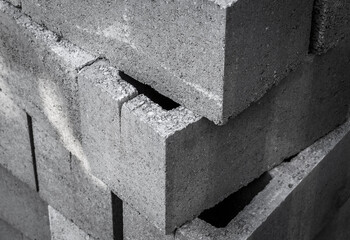 Large stack of gray concrete building blocks.