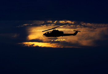 Fototapeta na wymiar Army helicopter flying at sunrise