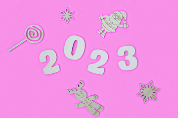 Happy New year 2023 number wood object on pink background and copy space - new year celebrate and business resource concept - marketing resource design mock up.