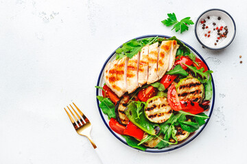 Healthy salad with grilled chicken breast fillet and vegetables: paprika, zucchini, eggplant, fresh...