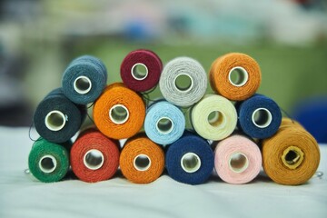 Close - up of coils of threads of different colors and shades for sewing, embroidery and...