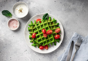 Green spinach waffles on table with linen tablecloth and cutlery. Healthy vegan food concept. flat...