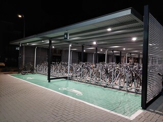 Modern chrome and black bicycle, bike shed at the railway station, trainstation in Belgium,...
