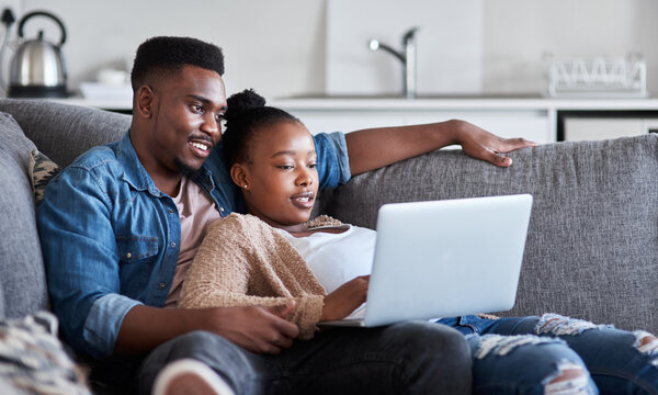 Black couple, laptop and living room sofa to relax while streaming movies, video or film with 5g network connection or home wifi. Man and woman on social media, reading news or doing online shopping