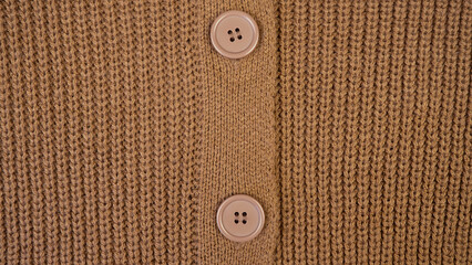 Texture of woolen knitwear.Natural woolen fabric, sweater fragment.Knitted pattern close-up.