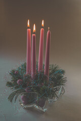 3 pink advent candles burning on round advent wreath, isolated, third advent week
