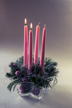 second pink advent candle burning on round advent wreath, isolated, second advent week
