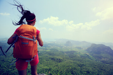 Successful woman hiker enjoy the view on mountain top