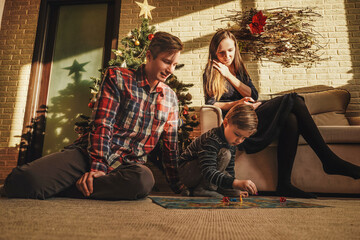 Happy family playing board game walker
