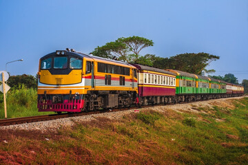 Fototapeta premium Passenger train by diesel locomotive on the railway.