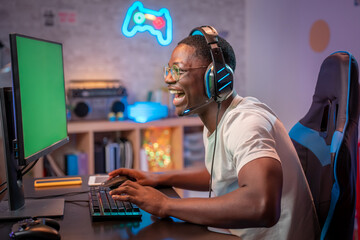 Young gamer playing online video games while streaming on social media - Player gaming esports on...