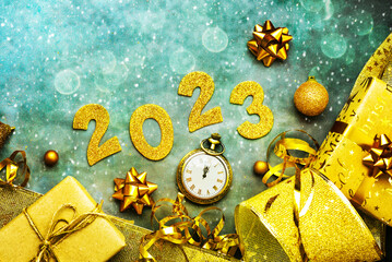 Happy new year 2023. Top view of golden Numbers 2023 with christmas ornament and antique clock. New...