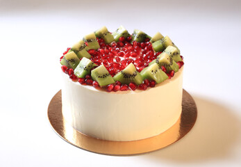 Cake with pomegranate and kiwi slices close-up