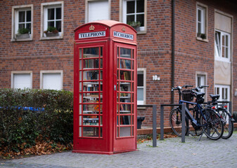  a bookcase that looks like a phone booth. Public bookcase in old red telephone box.