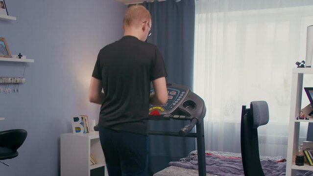 Man jogging on treadmill, medium shot