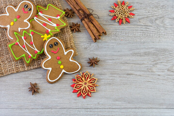 Christmas cookies. Making gingerbread cookies for Holidays.  Christmas cookies, gingerbread for the Christmas holidays on white wood with condiments scattered around. new year festival