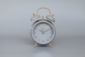 gray alarm clock on gray needle background