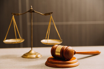 Business and lawyers discussing contract papers with brass scale on desk in office. Law, legal services, advice, justice and law concept