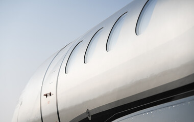 The windows of a small plane photographed from the exterior. Aviation industry airplane.