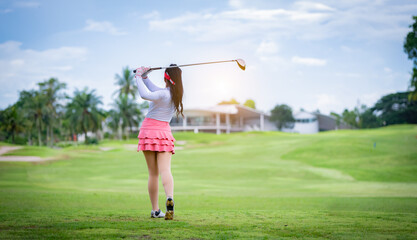 Professional woman golfer teeing golf in golf tournament competition at golf course for winner.	