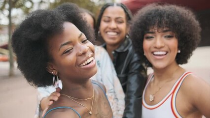 Multiethnic firends and a transgender woman posing while recording a video