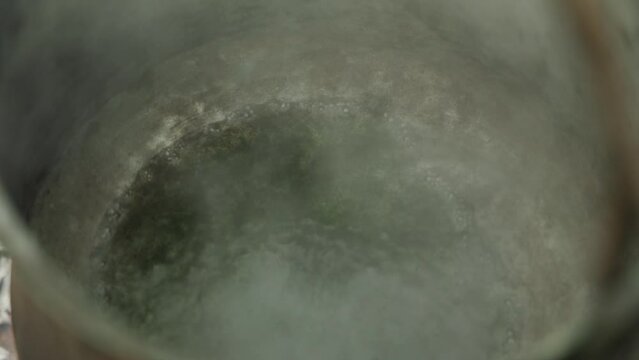 Boiling steam coming out of a which kettle, brewing potion, magical scene shot in closeup