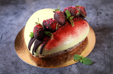 Dessert with chocolate-covered strawberries and mint in the form of a heart