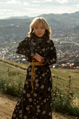 Beauty Mongolian woman in Ulaanbaatar with black traditional Mongolian clothing (Deel).