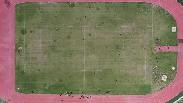 Amazing aerial view of a Ragbi field and players.