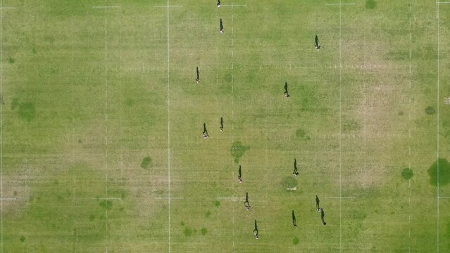 Amazing aerial view of a Ragbi field and players.