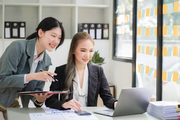 Portrait of Asian young female working on laptop at office