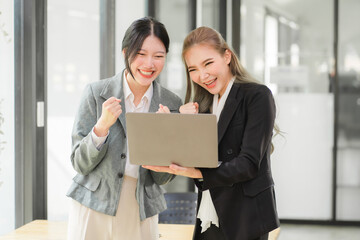 Portrait of Asian young female working on laptop at office