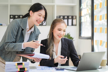 Portrait of Asian young female working on laptop at office