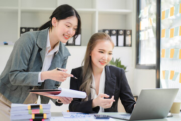 Obraz premium Portrait of Asian young female working on laptop at office