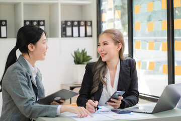 Portrait of Asian young female working on laptop at office