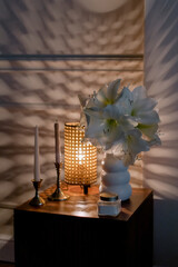 Night light and vase on the table. Delicate light. Beautiful candles in the room