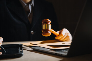 law books and scales of justice on desk in library of law firm. jurisprudence legal education...