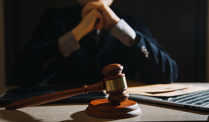 law books and scales of justice on desk in library of law firm. jurisprudence legal education...