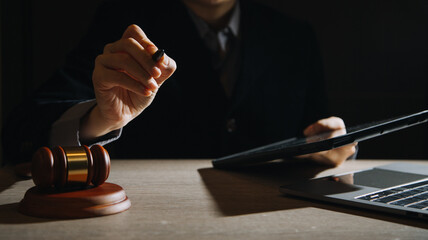 law books and scales of justice on desk in library of law firm. jurisprudence legal education...