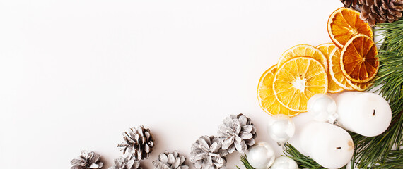 Christmas Banner. winter, new year composition. Fir tree branches, pine cone, dried oranges on white background. Flat lay, top view, copy space