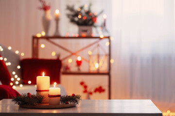 christmas decor in red color with burning candles at home