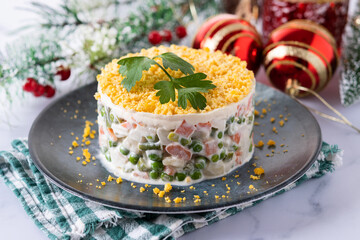 Russian salad or Olivier salad for Christmas dinner on white marble