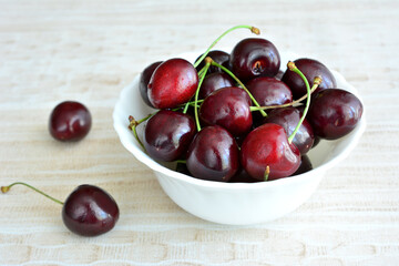 heap of ripe cherries in bowl isolated, close-up