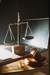 Business and lawyers discussing contract papers with brass scale on desk in office. Law, legal services, advice, justice and law concept picture with film grain effect