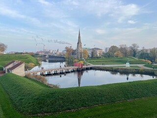 Obraz premium reflection of St Alban's Church in the canal of the fortres
