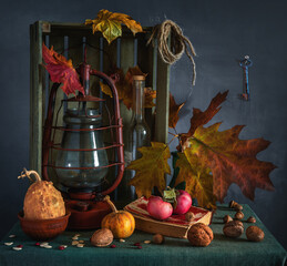 on the table in the pantry there is a box with a kerosene lamp, vegetables and fruits