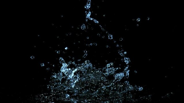Super slow motion of splashing water crown shape on black background. Filmed on high speed cinema camera, 1000fps. Speed ramp effect.