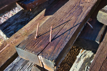 old rusty nails sticking out of wooden plank