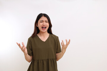 Stressed and frustrated young asian woman standing against white background with copyspace